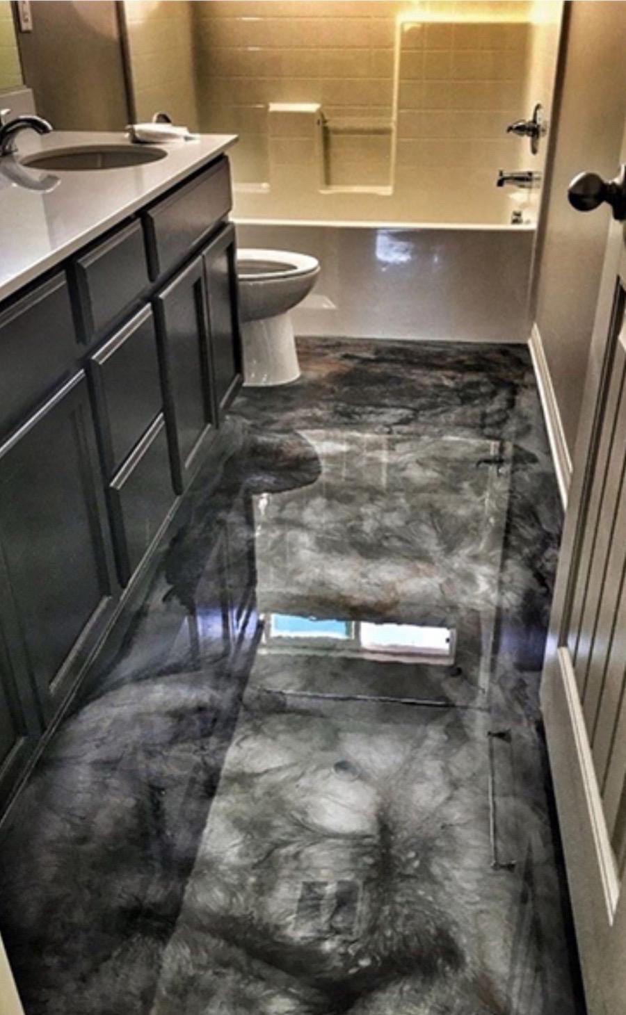 Dark metallic epoxy floor in a bathroom